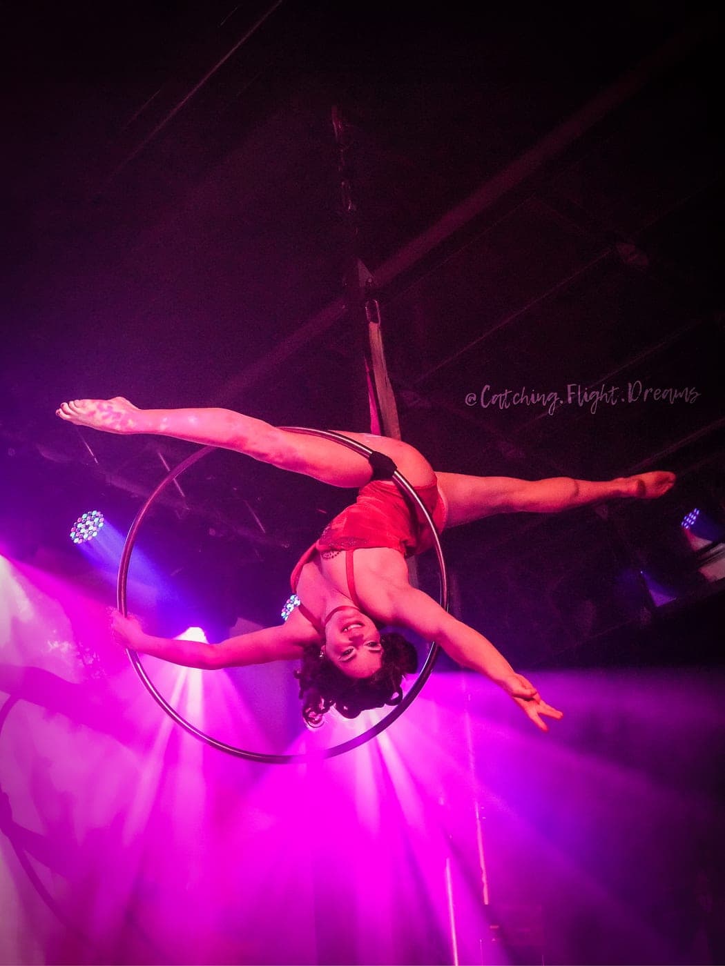 An aerialist performing on silks