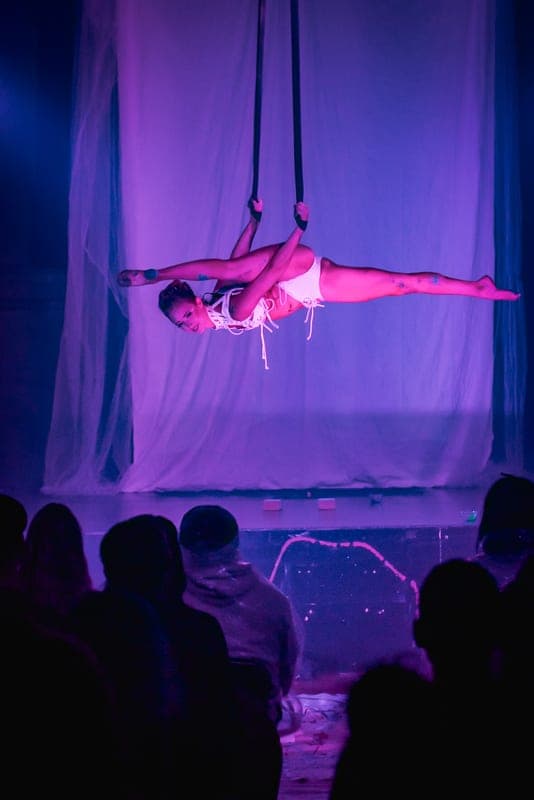 A performer on aerial straps
