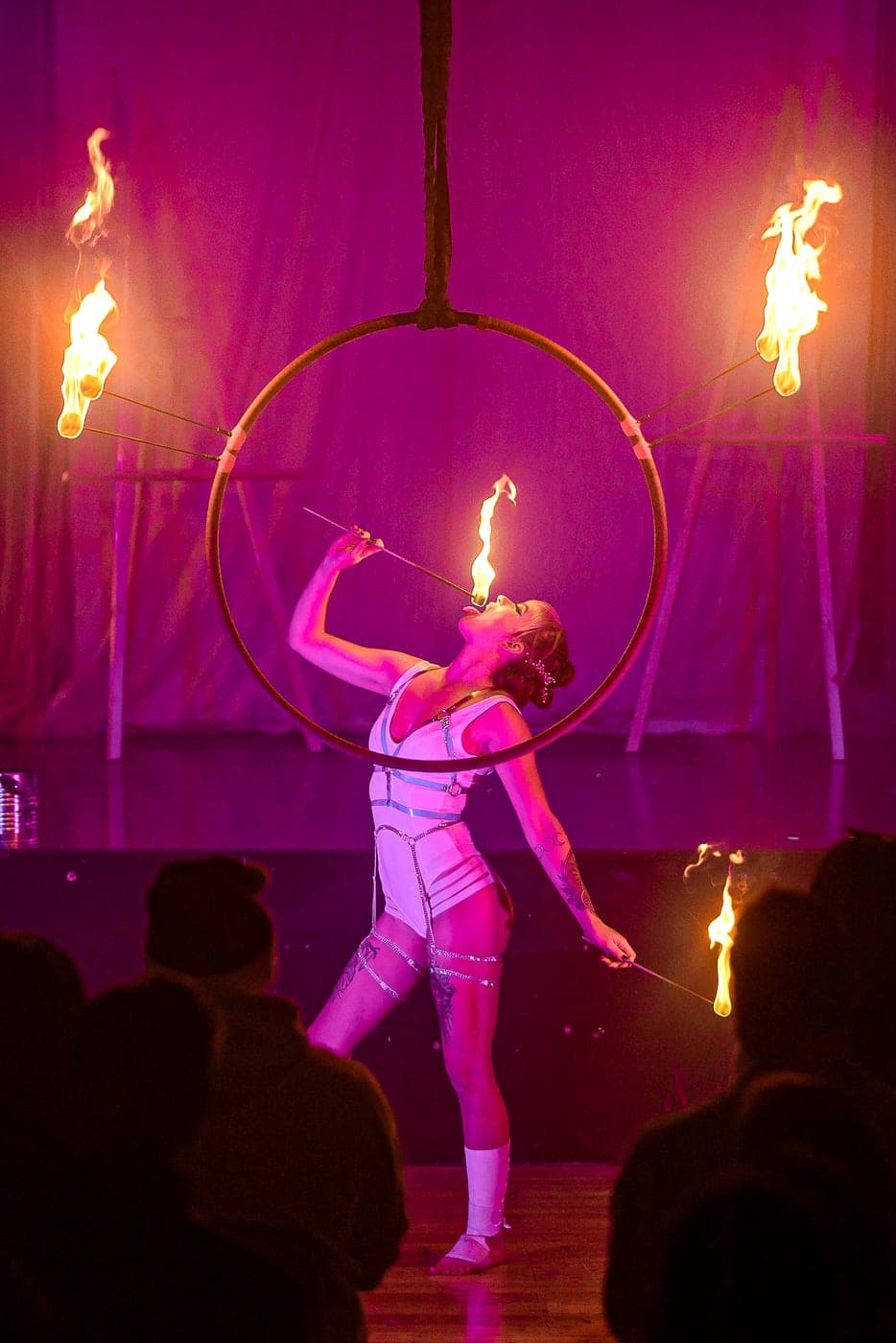A fire performer spinning lit props