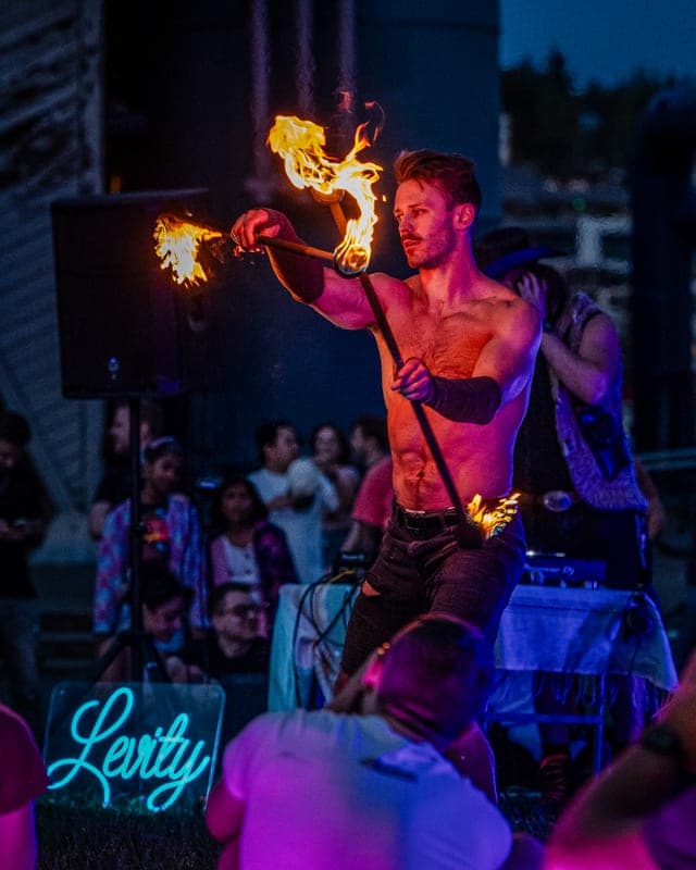 A performer spinning double staff