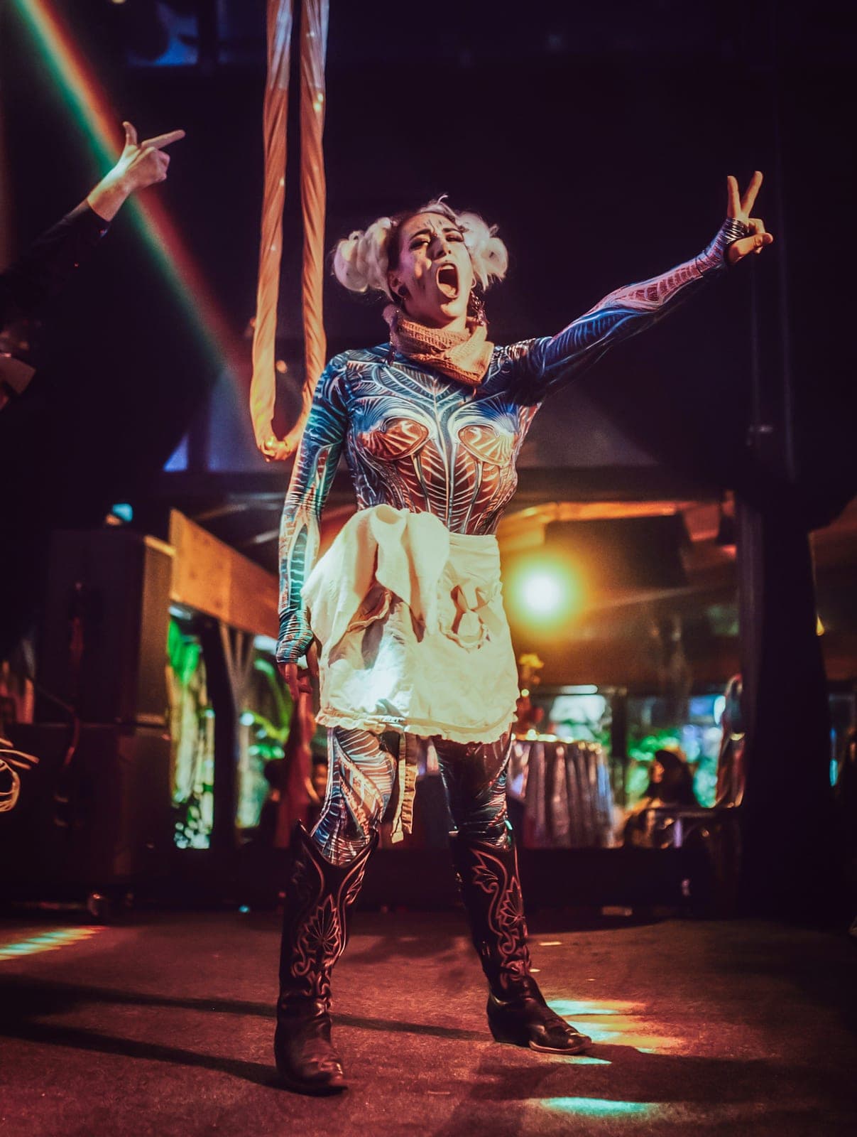 A Levity character performer working the room, arms raised mid-shout