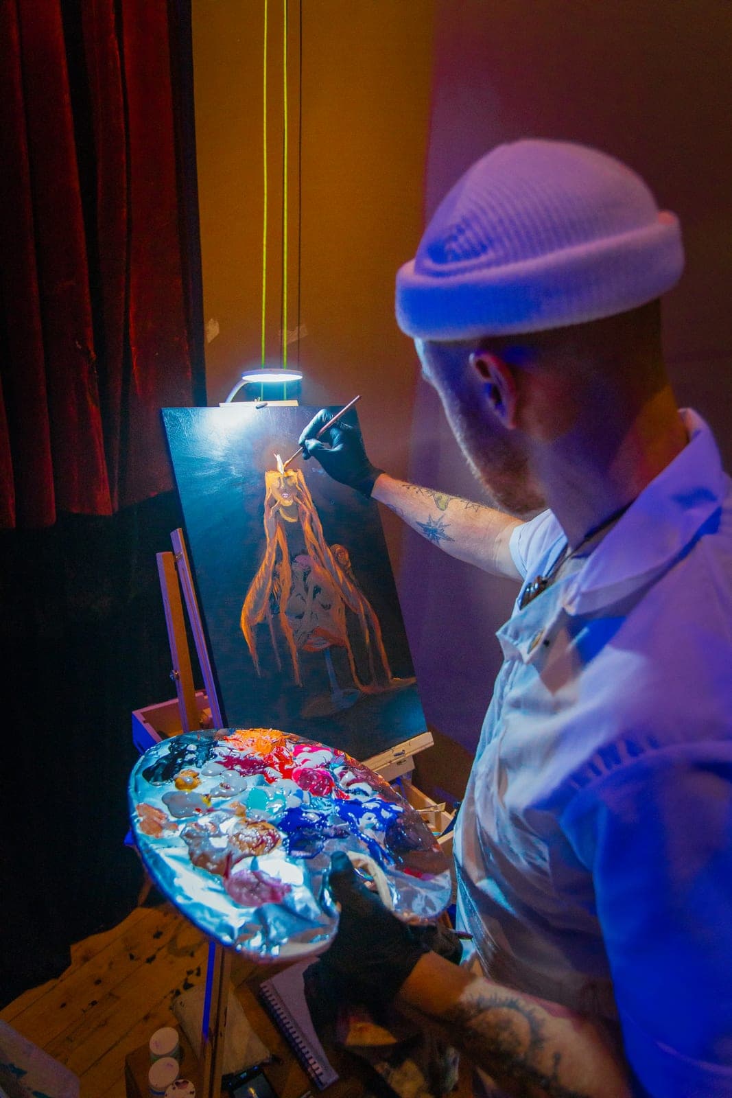 A visual artist painting live at a Levity show