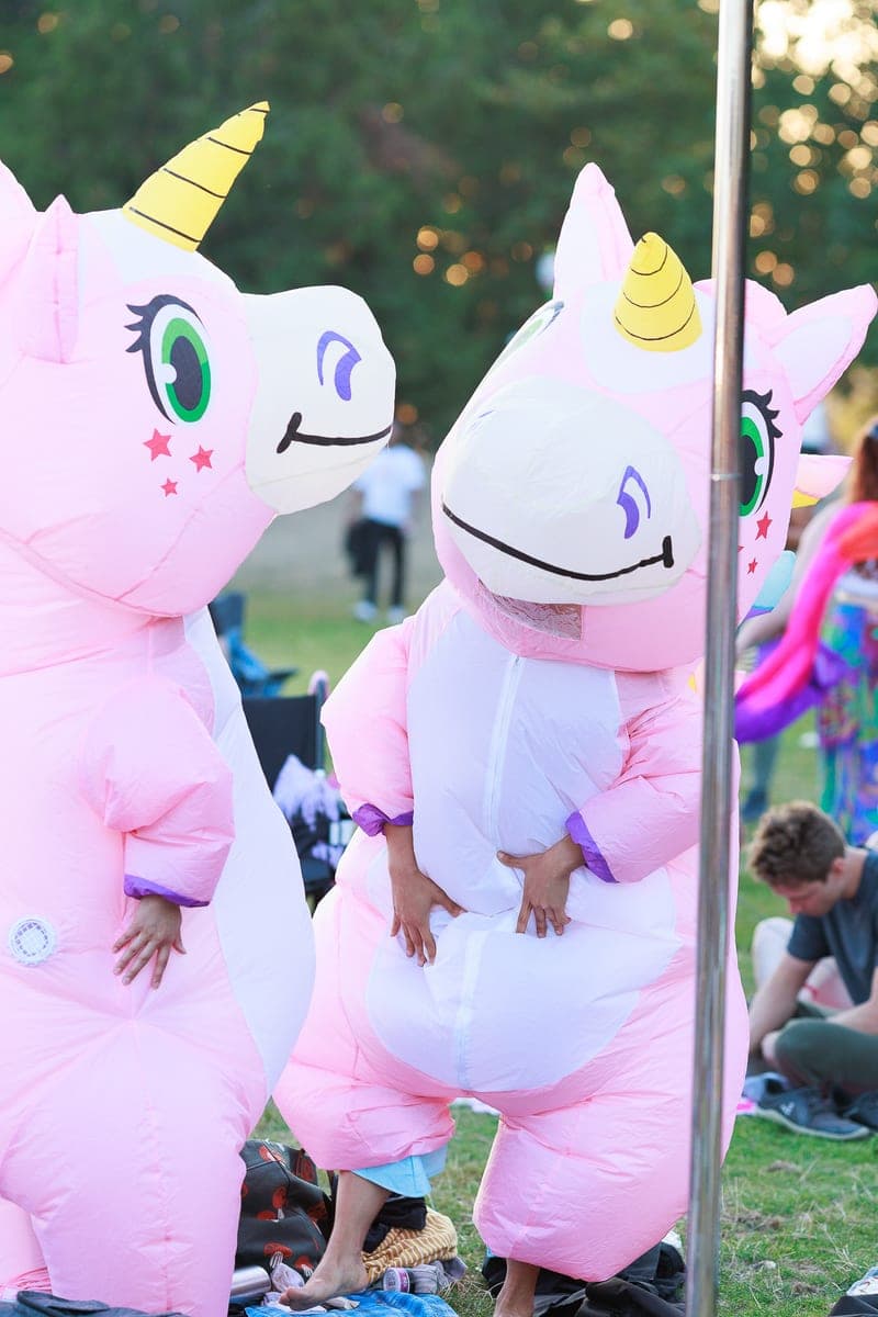 Two people in inflatable unicorn costumes at a Gas Works community event